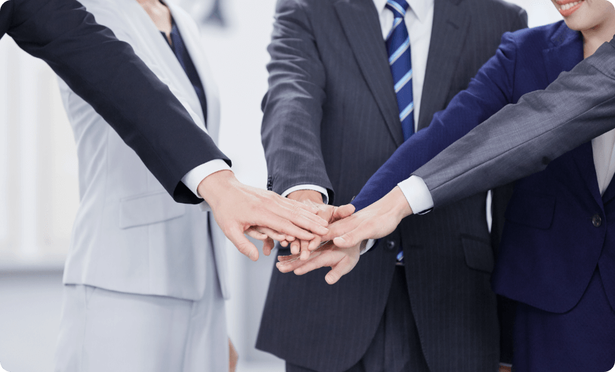 手のひらを重ねて円陣を組む会社員